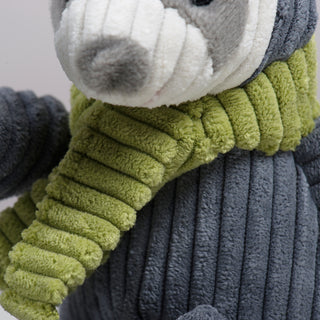 Close up image of green scarf on sloth shaped plush dog toy.