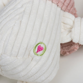 Close up of corduroy texture and HuggleHeart logo on Lillie Llama.
