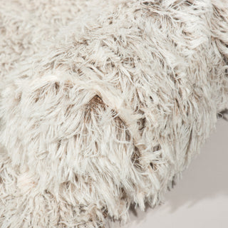 Close up view of gray fluffy couch and bed protector.