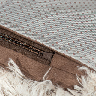 Close up view of the stiching and zipper used to keep the fabric inside of gray durable and fluffy sofa and bed protector.