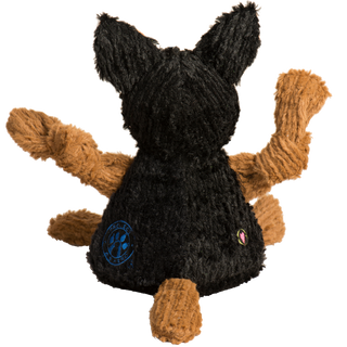 Photo of a black and tan German Shepherd dog toy . This is a photo of the back of the toy. You can see the back of his black body, head and ears as well as his tan tail, arms and legs. You can also see the embroidered blue log of the Project K-9 Hero and the HuggleHounds heart.