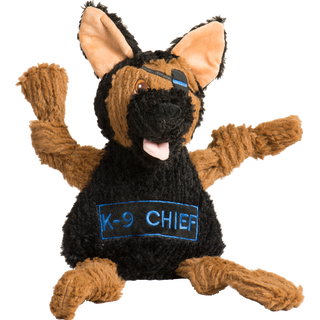 Photo of a black and tan German Shepherd dog toy . He has an eye patch over his left eye. On his belly his name, K-9 Chief, is embroidered.