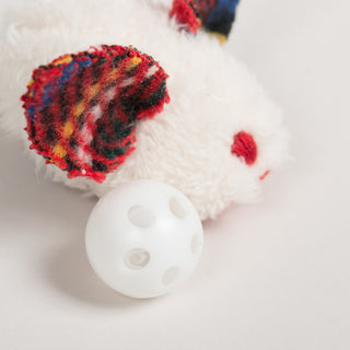 Tartan-eared HuggleKats mouse toy next to a white plastic rattle ball insert.