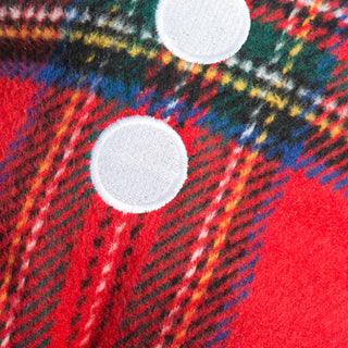 Zoomed-in shot of button and trim detailing on the red plaid fabric of Plaid McButtons dog toy.