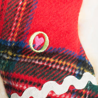 Close-up of the embroidered heart detail on the front tartan side of the Plaid McButtons dog toy.