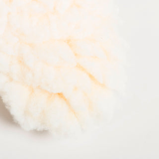Close-up of the fluffy HuggleFleece edge surrounding Plaid McButtons plush dog toy.
