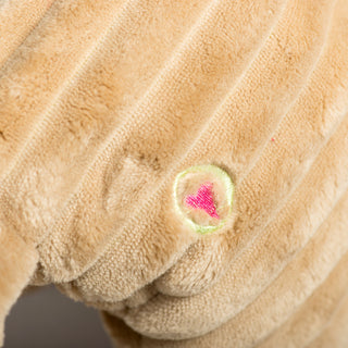 Close-up of HuggleHounds® embroidered heart logo on the side of Reindeer Squooshie dog toy.