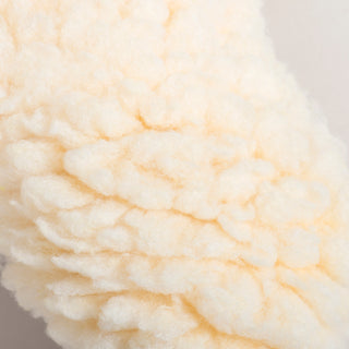 Macro detail of the ultra-soft, faux-lambswool HuggleFleece® fabric used on the back side of the bone toy.
