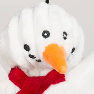 Close-up of the Snowman HuggleFlatties toy's face showing detailed embroidered eyes and carrot nose.