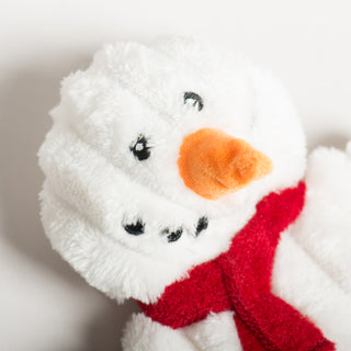 Close-up of Snowman HuggleFlattie's face with orange carrot nose and stitched eyes.