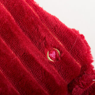 Detail of red corduroy fabric and embroidered heart on St. Nick HuggleFlattie.