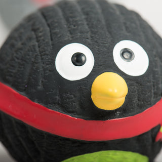 Front view of a black Ruff-TexÂź penguin dog toy with a red scarf and yellow beak.