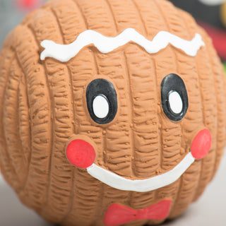 Smiling gingerbread face on a brown Ruff-TexÂź holiday toy with red cheeks and a red bow tie.