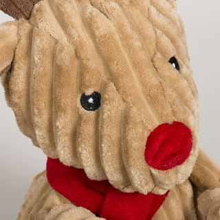 Close-up of Rudy Reindeer Knottie plush toy showing its red nose, embroidered eyes, and soft corduroy texture.