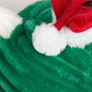 Close-up of Noe Narwhal Knottie® plush toy's red Santa hat with white pom-pom and faux-fur trim.