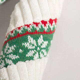 Detailed view of red and green Nordic knit pattern on the plush candy cane dog toy.