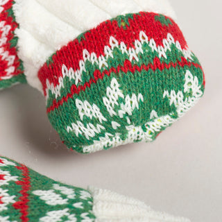 Close-up of green and white snowflake knit pattern on the candy cane plush dog toy.