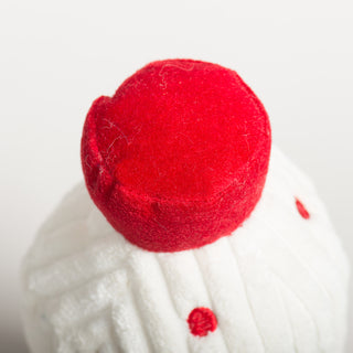 Close-up of a red milk bottom top on a white background