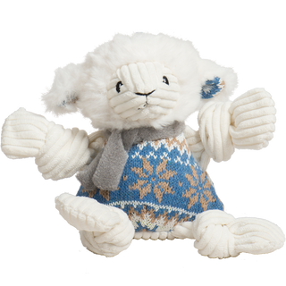 Plush toy lamb wearing a blue sweater with a snowflake pattern on a white background