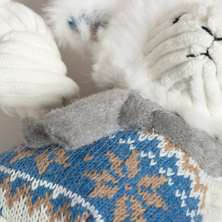 Close-up of knitted fabric with blue and brown pattern on a white background