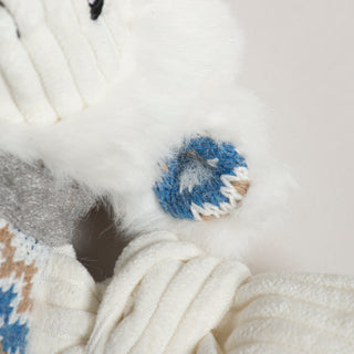Close-up of a knitted item with blue and beige pattern on a white background