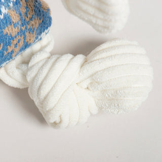 Close-up of white textured fabric with a blue patterned corner on a light gray background