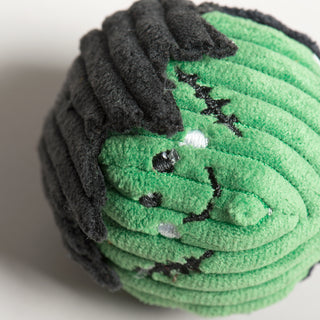 Close-up of Frankenstein-themed cat toy showing embroidered stitches and face