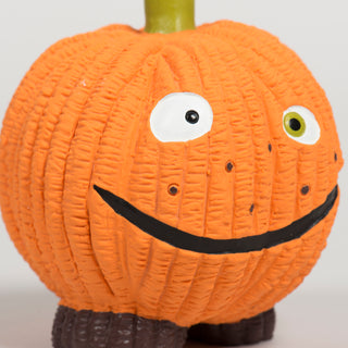 Close-up of the large Gourdie Ruff-Tex ball toy showing goofy eyes, black smile, and textured pumpkin design.