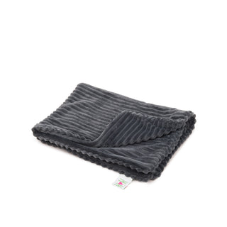 Charcoal colored scout blanket folded, and on the ground.