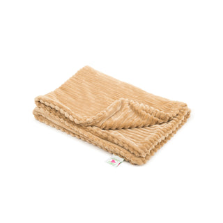Natural colored scout blanket folded, and on the ground.