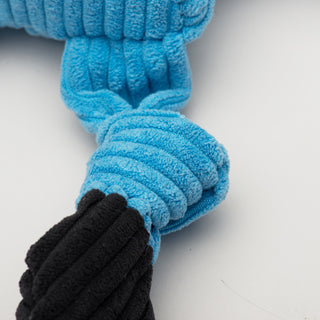 Close up view of blue knotted limb with black shoes to show corduroy details.