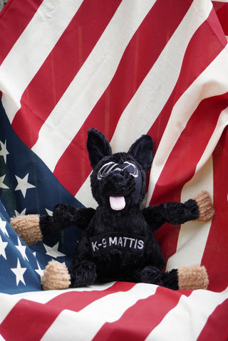 K-9 Mattis KnottieÂŽ dog toy with American flag background