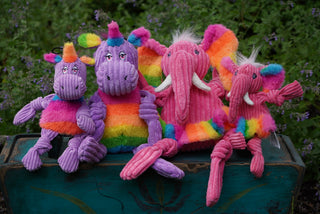Set of four rainbow plush Knotties®; two purple unicorns and two pink elephants in small and large.