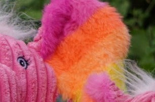 Close up view to show texture of rainbow faux-fur