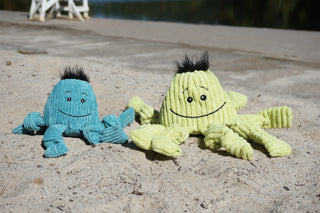 Large and small Octavie Octopus' Knotties® sitting in sand.