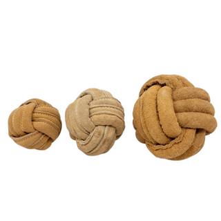 Three tan natural leather knotted ball dog toys in small, medium, and large lined up.