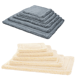 two stacks of HuggleFleece mats. One is gray and one is a natural colored stack of mats.