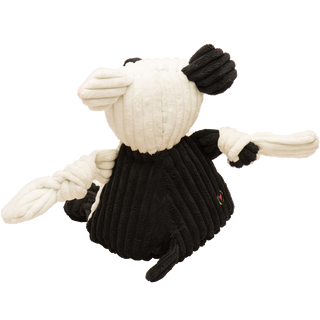 Back view of Jonny Justice durable plush corduroy dog toy: the dog has white and black fur, black and white furred right arm, black fur on the back, black furred legs, white paws, and is squeaky with knotted limbs.