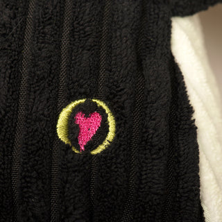 Close up image of HuggleHeart logo on Jonny Justice durable plush corduroy dog toy.
