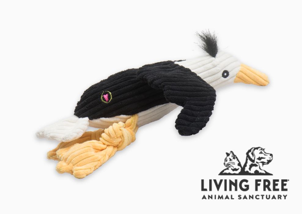 Living Free logo next to black, white, and yellow plush Knottie® seagull.