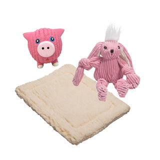 Set of three natural colored mat, squeaky ball shaped pig dog toy, and bunny shaped plush dog toy: Pig has pink fur, light-pink nose, and white feet. The bunny has white hair, pink fur, white inner-ear, and pink knotted limbs. The mat is in the color natural and is in the size extra small.