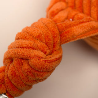 Close up of knotted limb on Astronaut durable plush dog toy.