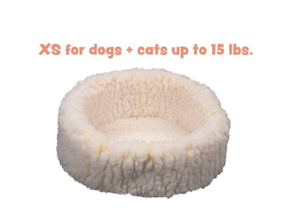 XS sized natural colored HuggleFleece® dog/cat bed with text "XS for dog + cats up to 15 lbs.".