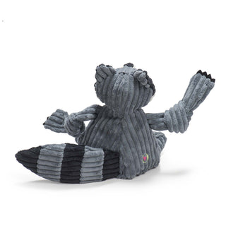 Back of raccoon shaped plush dog toys: has a gray-blue furred head, body, and knotted limbs, black claws, with gray-blue and black striped tail.