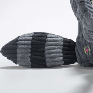 Close up view of raccoon shaped plus dog toys black and gray-blue striped tail.