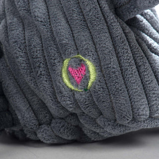 Close up view of HuggleGroup logo on raccoon shaped plush dog toy lower back.
