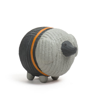 Side view of grey poodle with orange collar squeaky latex ball dog toy.