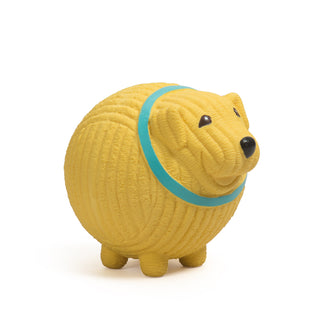 Side view of yellow golden retriever with blue collar squeaky latex ball dog toy.