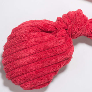 Close up view of red, knotted, lobster claw and showing corduroy fabric details.