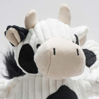 Close up of Dottie Cow Knottie. White face, black spots, two off-white antlers, plush off-white mouth. Thumbnail